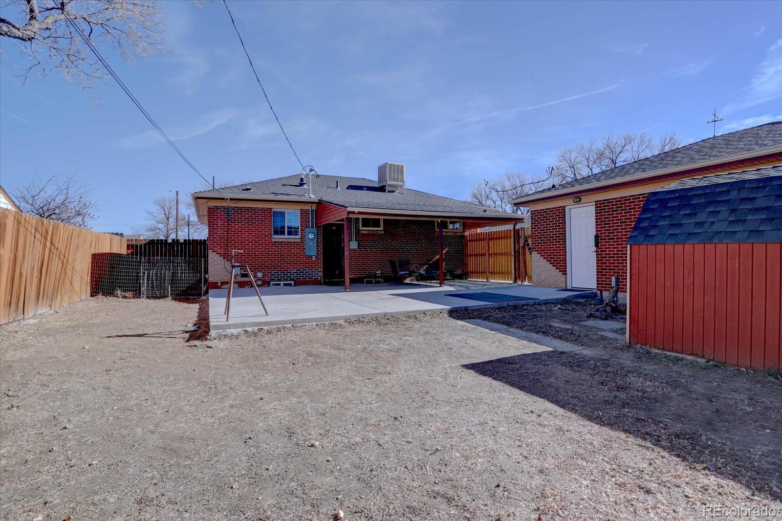 7141 Raritan Street Denver, CO 80221 - Photo 26 of 29 a view of house with backyard and parking