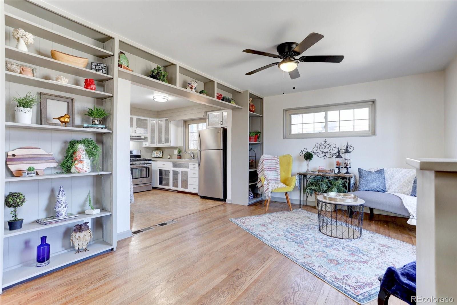 7141 Raritan Street Denver, CO 80221 - Photo 3 of 29 a living room with furniture and wooden floor