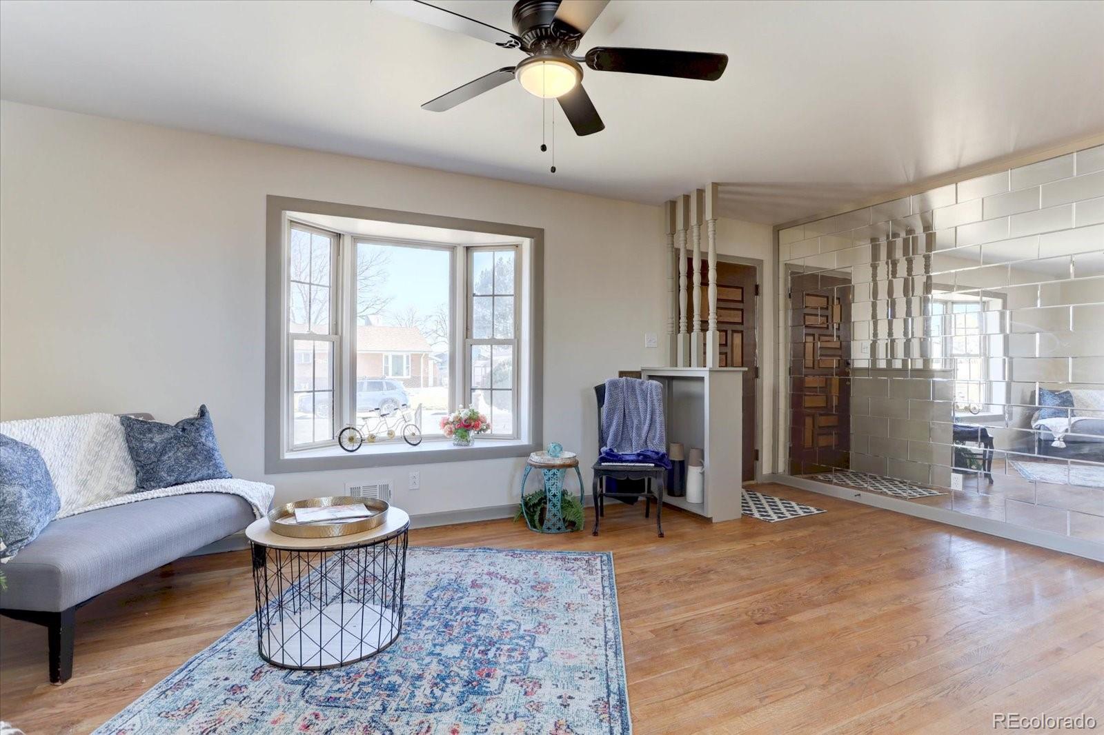 7141 Raritan Street Denver, CO 80221 - Photo 4 of 29 a living room with furniture and wooden floor