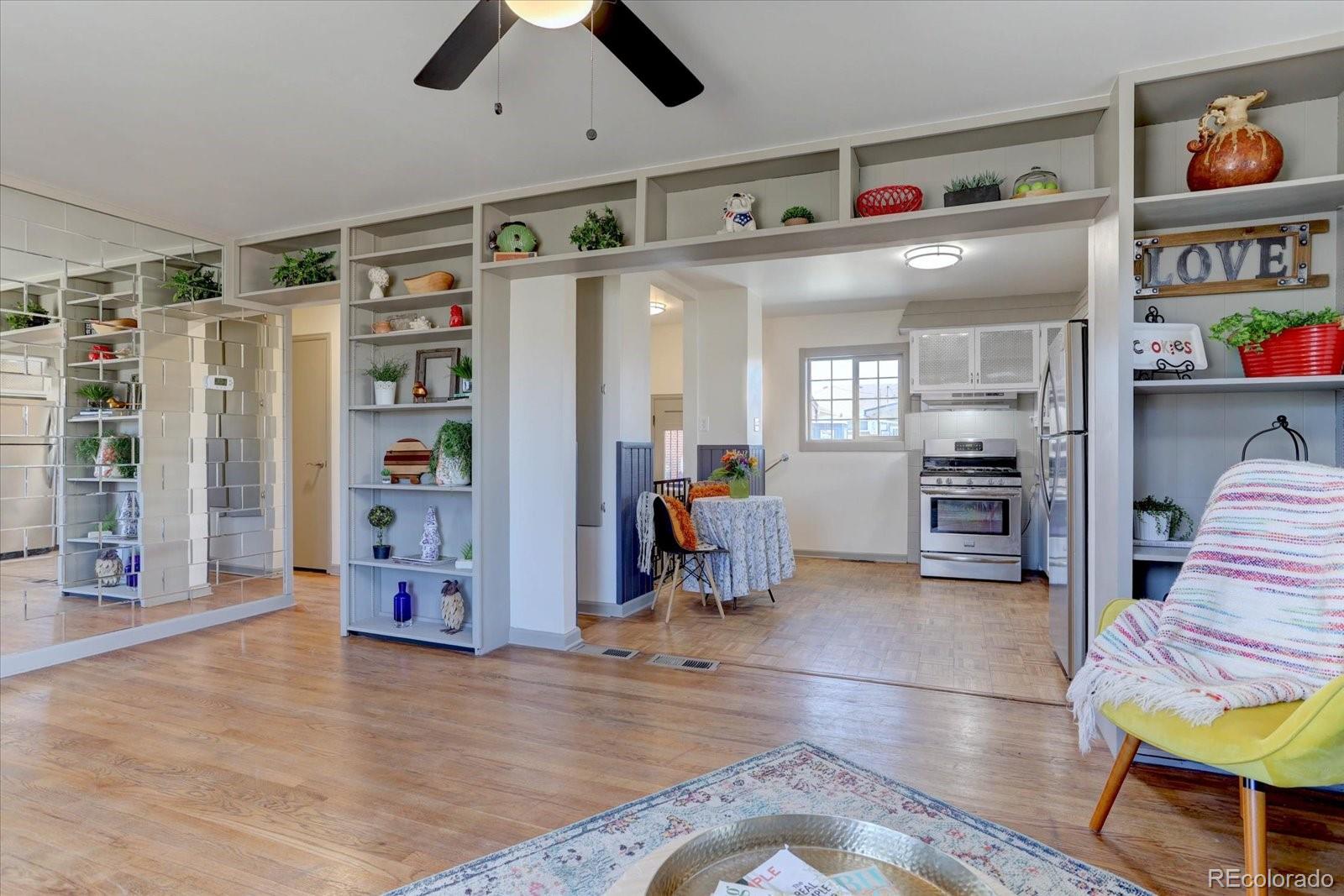 7141 Raritan Street Denver, CO 80221 - Photo 5 of 29 a living room with lots of furniture and a kitchen