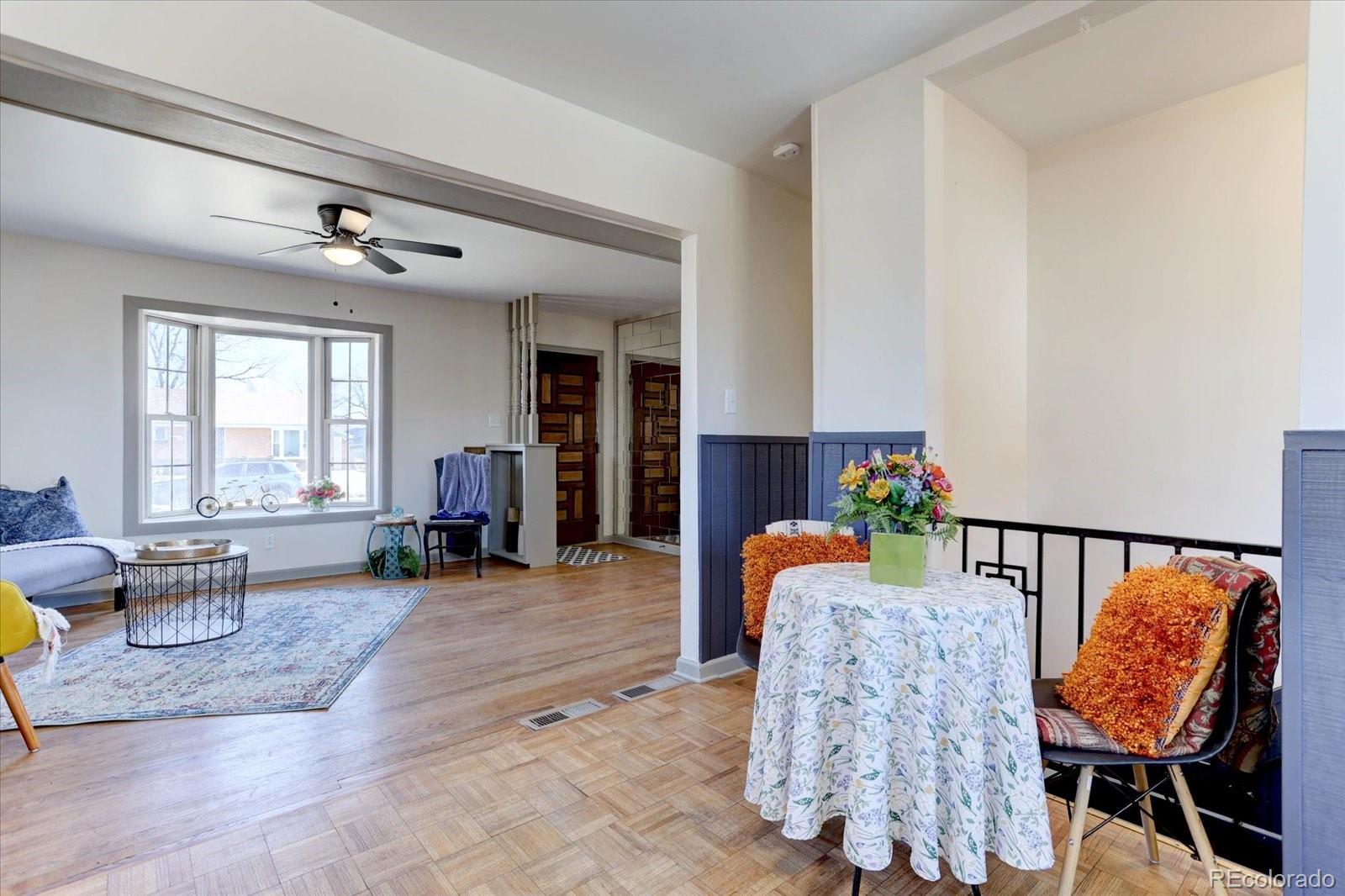 7141 Raritan Street Denver, CO 80221 - Photo 7 of 29 a living room with furniture and wooden floor