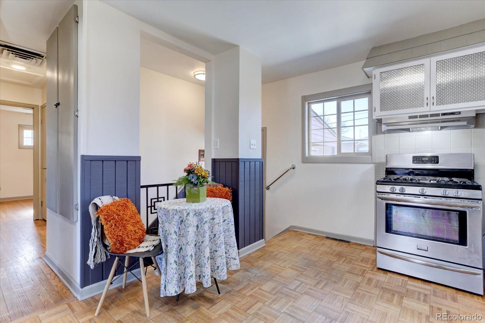 7141 Raritan Street Denver, CO 80221 - Photo 8 of 29 a kitchen with stainless steel appliances granite countertop a stove a sink and a refrigerator