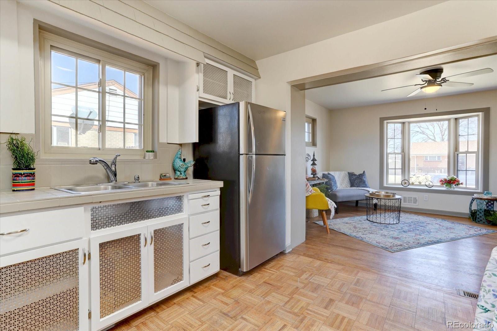7141 Raritan Street Denver, CO 80221 - Photo 9 of 29 a kitchen with a refrigerator and a sink