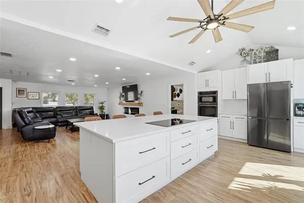 a kitchen with stainless steel appliances a refrigerator sink and cabinets
