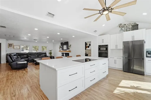 a kitchen with stainless steel appliances a refrigerator sink and cabinets