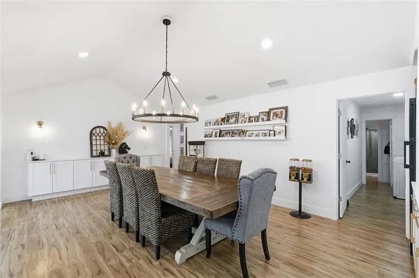 a view of kitchen with stainless steel appliances kitchen island sink stove and refrigerator