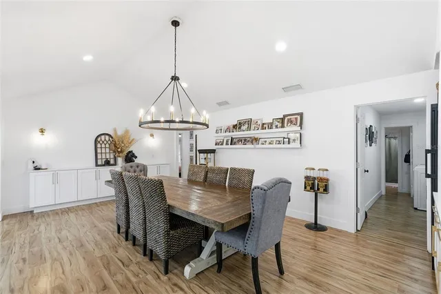 a view of kitchen with stainless steel appliances kitchen island sink stove and refrigerator