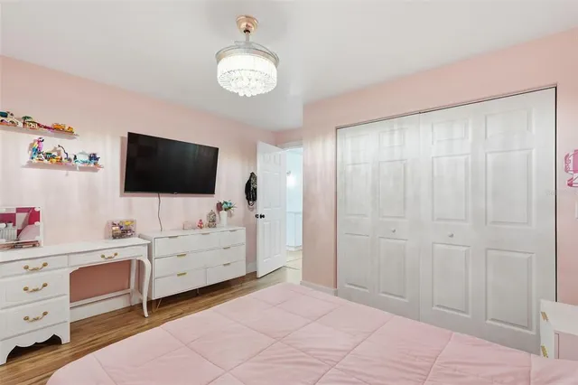 a bedroom with a bed desk and a window