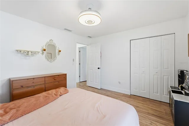 a kitchen with stainless steel appliances granite countertop white cabinets and a refrigerator