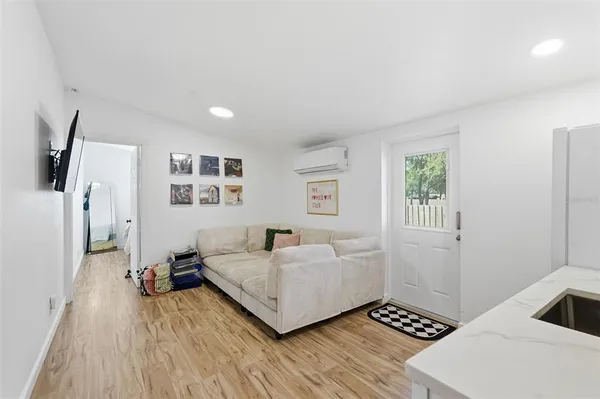 a room with wooden floor and gym equipment