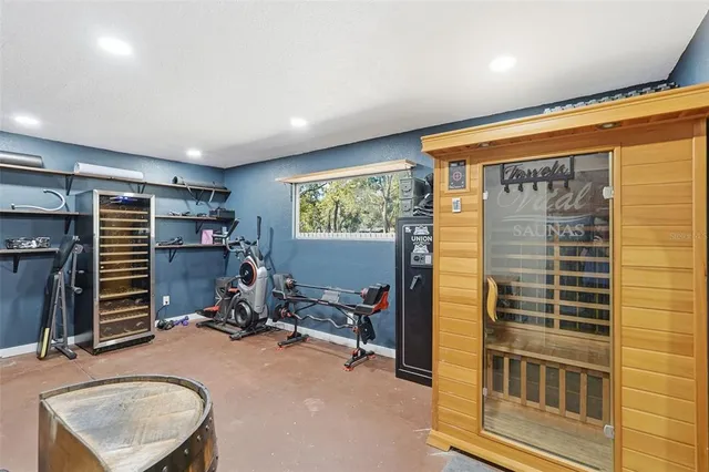 a living room with furniture a flat screen tv and a floor to ceiling window