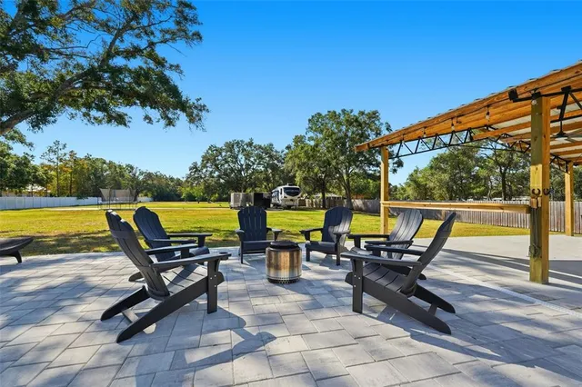 an aerial view of a house with a yard and lake view
