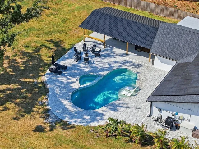 an aerial view of residential houses with outdoor space