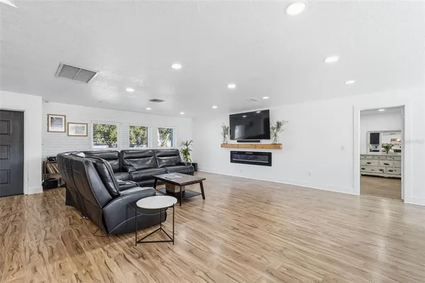 a living room with furniture and a wooden floor