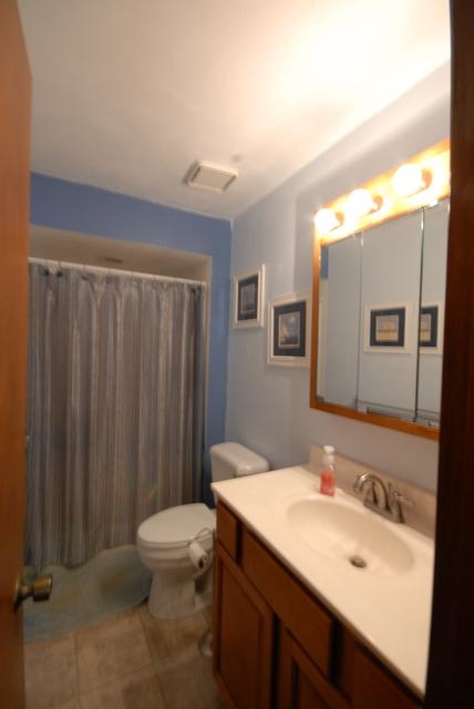 4154 Gloucester Road Roscoe, IL 61073 - Photo 11 of 22 a bathroom with a sink a toilet and mirror