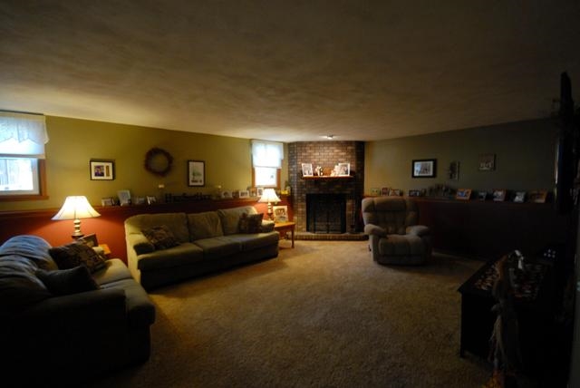 4154 Gloucester Road Roscoe, IL 61073 - Photo 17 of 22 a living room with furniture a fireplace and a flat screen tv