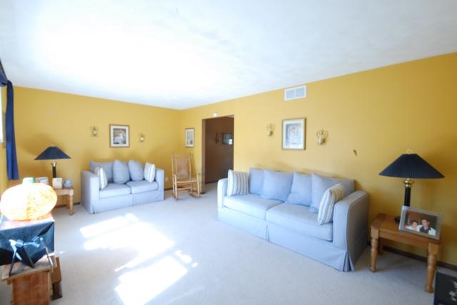 4154 Gloucester Road Roscoe, IL 61073 - Photo 2 of 22 a living room with furniture and a lamp