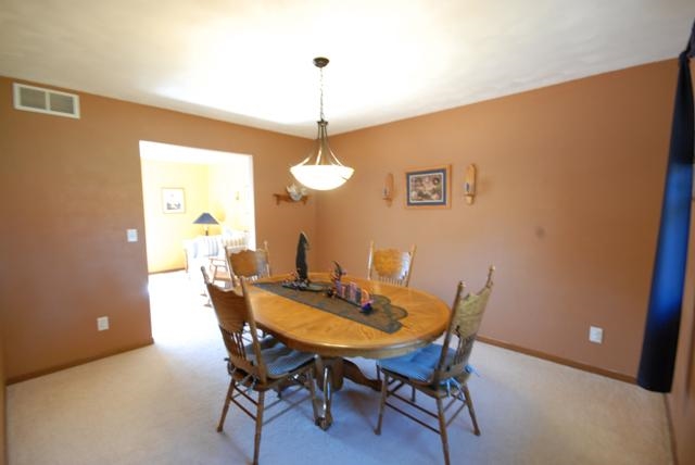 4154 Gloucester Road Roscoe, IL 61073 - Photo 5 of 22 a view of a dining room with a table and chairs