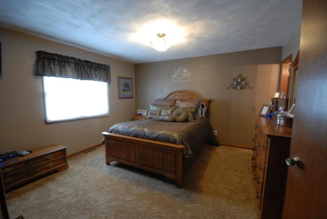 4154 Gloucester Road Roscoe, IL 61073 - Photo 9 of 22 a bedroom with a bed and window