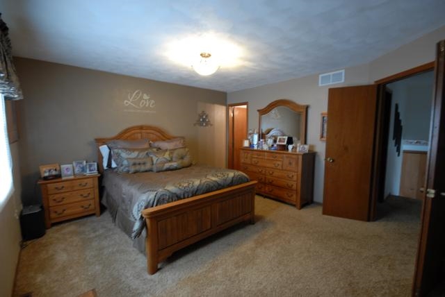 4154 Gloucester Road Roscoe, IL 61073 - Photo 10 of 22 a bedroom with a bed and a large window