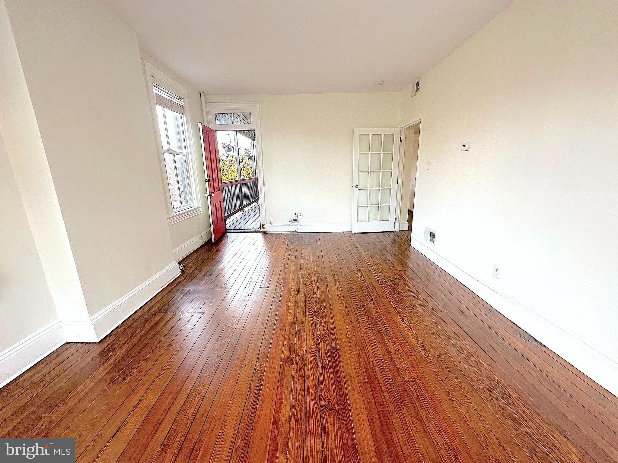 1133 D Street Northeast, Unit 2A Washington, DC 20002 - Photo 10 of 14 an empty room with wooden floor and windows