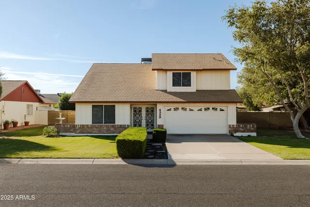 a view of a house with pool and a yard