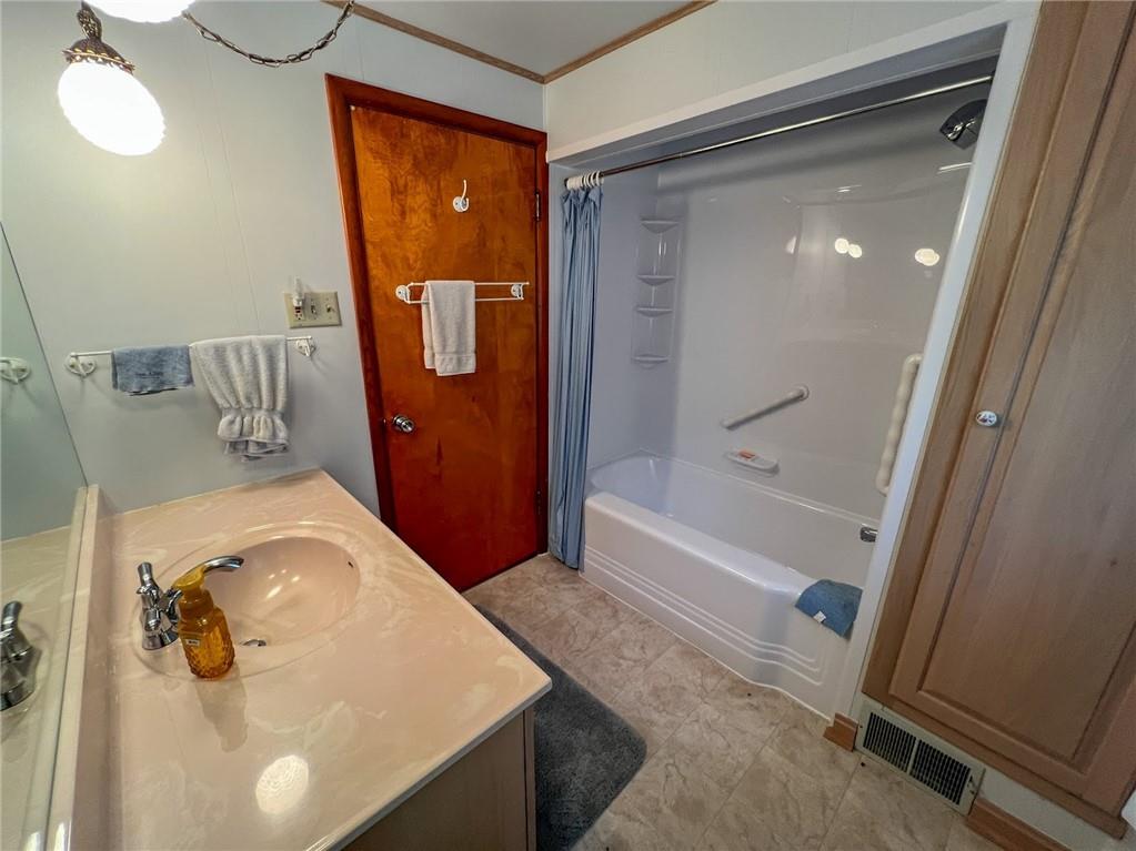 201 Beech Road Butler, PA 16001 - Photo 13 of 49 a bathroom with a tub sink and mirror
