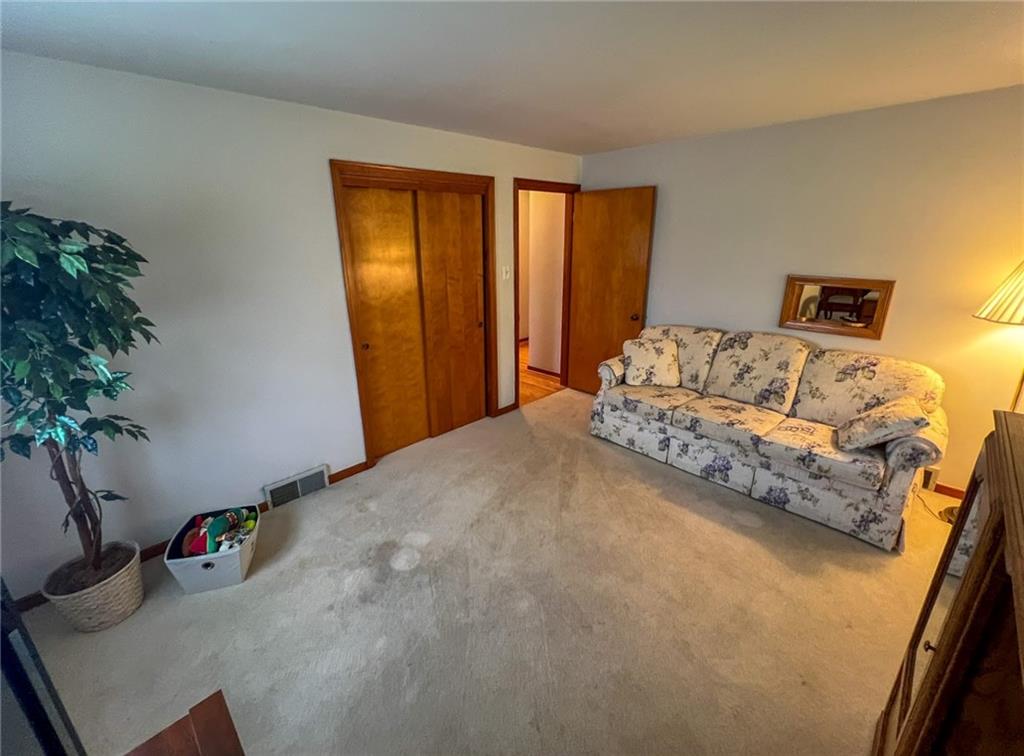 201 Beech Road Butler, PA 16001 - Photo 21 of 49 a bedroom with a bed and a potted plant