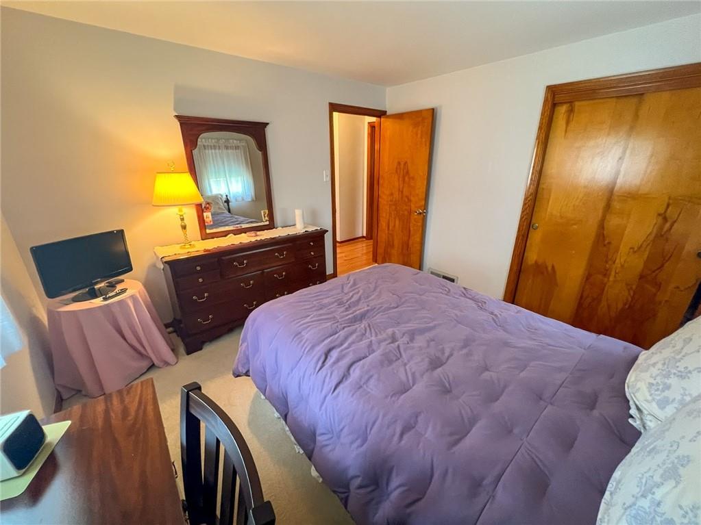201 Beech Road Butler, PA 16001 - Photo 25 of 49 a bedroom with a bed and a flat tv screen on dresser