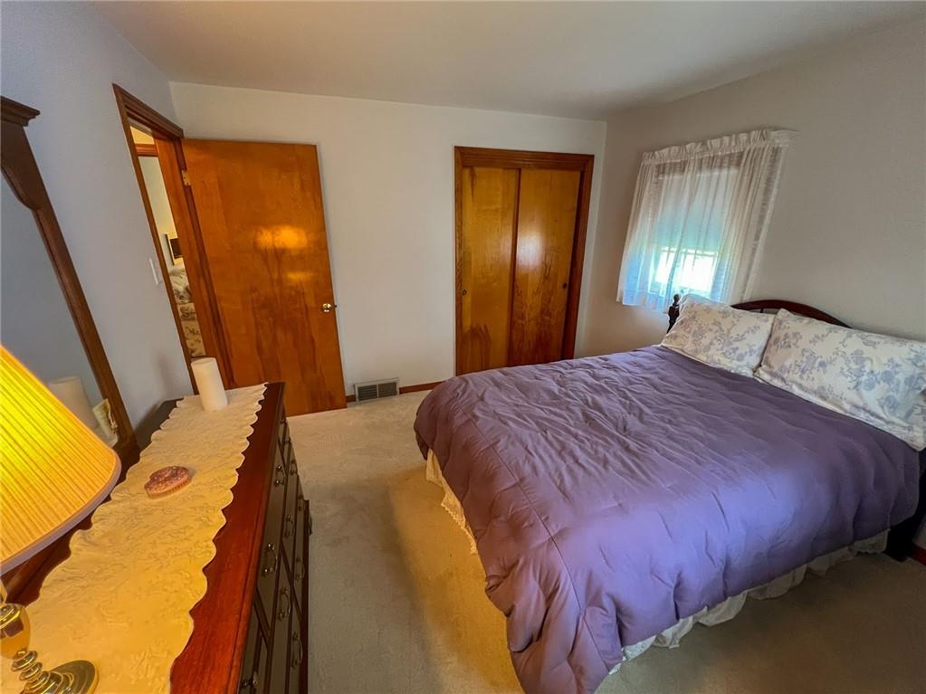 201 Beech Road Butler, PA 16001 - Photo 26 of 49 a bedroom with a bed and wooden floor