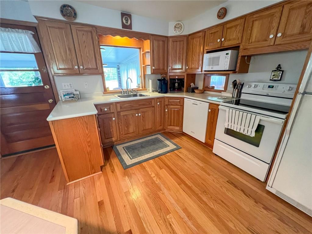 201 Beech Road Butler, PA 16001 - Photo 38 of 49 a kitchen with stainless steel appliances granite countertop a stove a sink dishwasher and a microwave with wooden floor