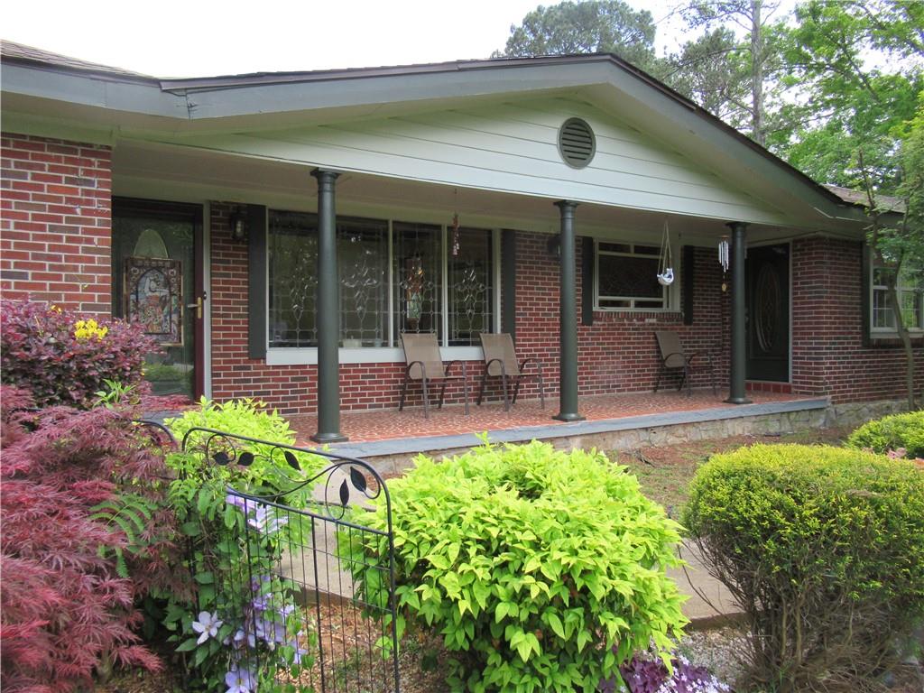 4500 Klondike Road Lithonia, GA 30038 - Photo 1 of 1 Front exterior of this four sides brick beauty with covered front porch & large rear deck, located on four acres just 1/2 mile from Arabia Mountain with plenty of recreational opportunities and trails.