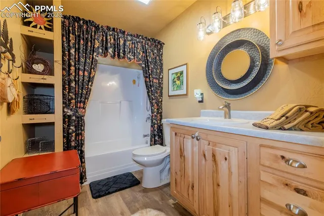 a bathroom with a toilet a sink and a mirror