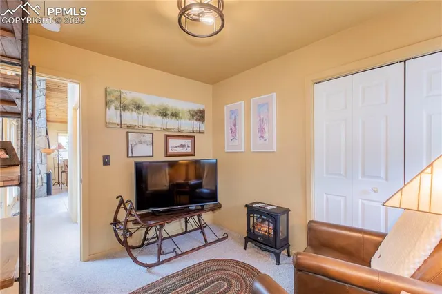 a living room with furniture a flat screen tv and a window