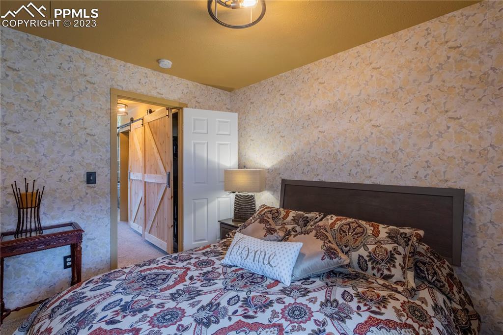 93 Water Street Guffey, CO 80820 - Photo 10 of 23 a bedroom with a bed and wooden floor