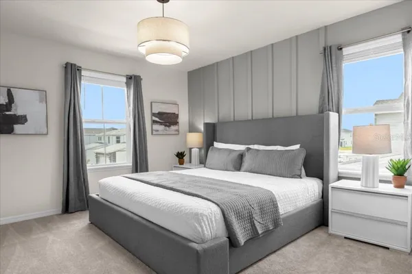 a bedroom with a bed and a chandelier
