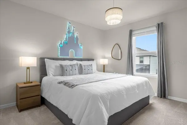 a bedroom with two beds and painting on the wall
