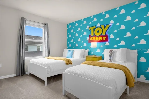 a bedroom with a bed and a chandelier