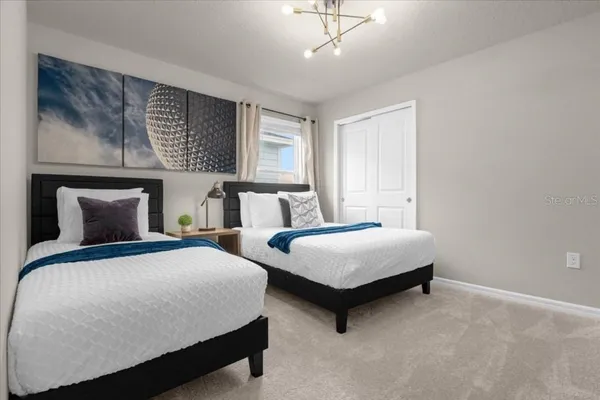 a bedroom with two beds and window