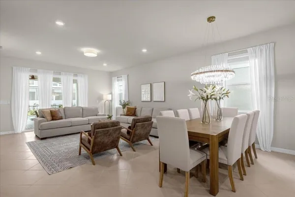 a living room with furniture and a chandelier