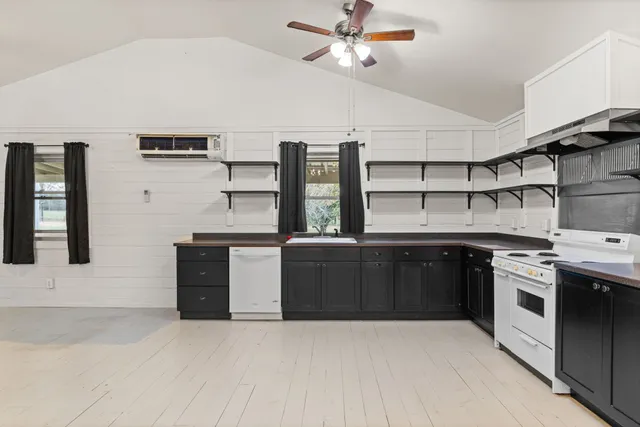 a kitchen with stainless steel appliances granite countertop a stove and a refrigerator