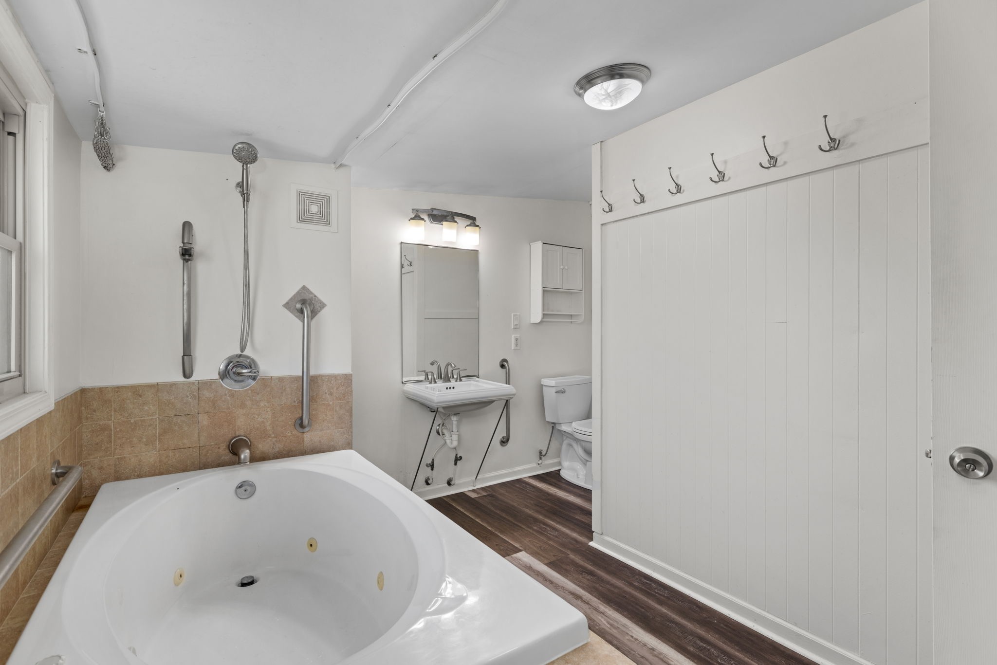 9680 Buttermilk Ridge Road Lawrenceburg, TN 38464 - Photo 14 of 61 a bathroom with a white tub shower and vanity