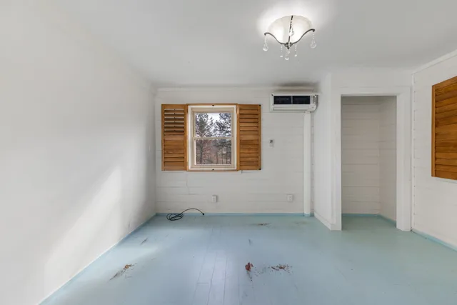 a view of a kitchen with a sink and dishwasher a kitchen island with wooden cabinets