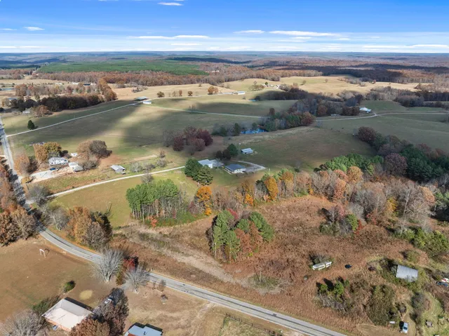 a view of a house with a yard covered in snow