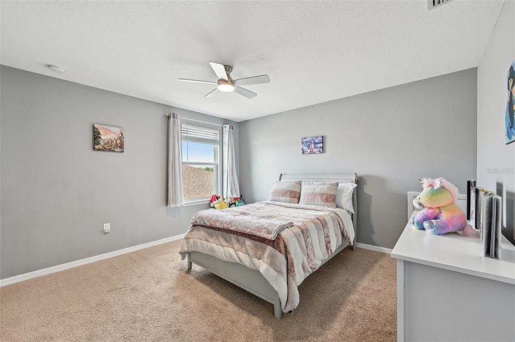 4515 Bent Tree Boulevard Sarasota, FL 34241 - Photo 17 of 34 a bedroom with a bed chandelier and a window