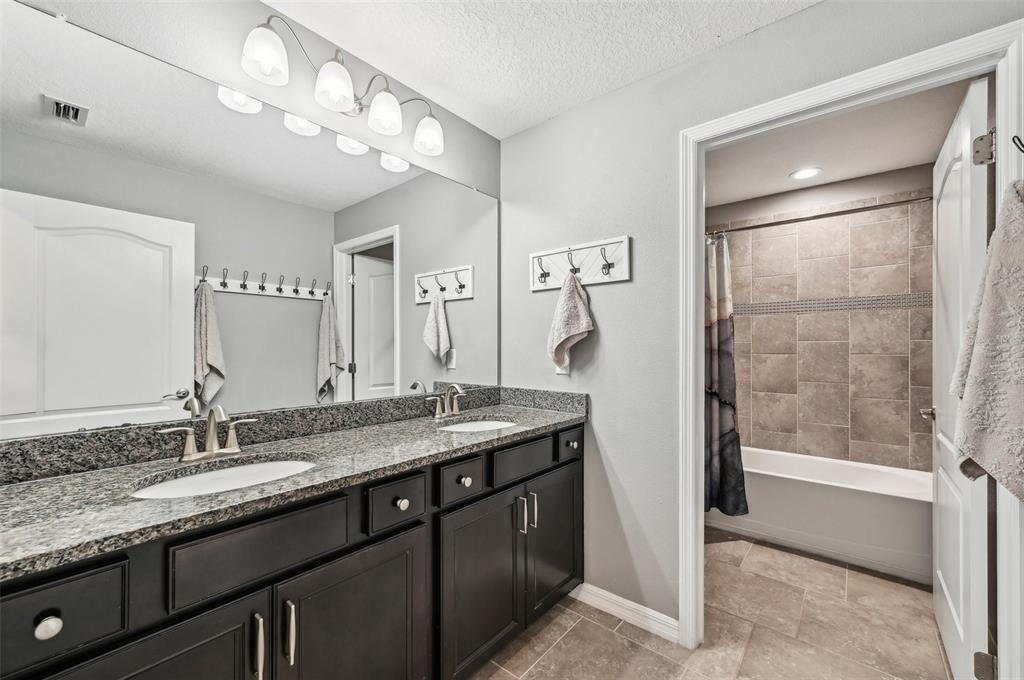 4515 Bent Tree Boulevard Sarasota, FL 34241 - Photo 20 of 34 a bathroom with a granite countertop sink a mirror and a shower