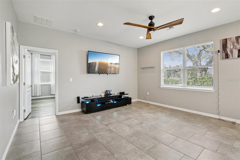 4515 Bent Tree Boulevard Sarasota, FL 34241 - Photo 3 of 34 a living room with furniture and a ceiling fan