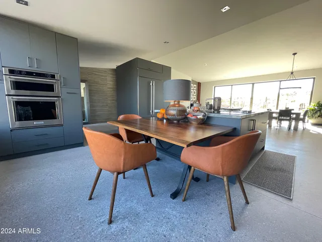 a bedroom with a large bed and a large window