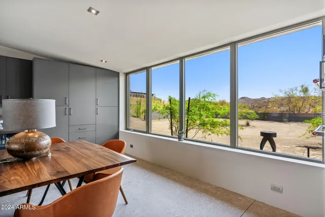 a bedroom with a bed and painting on the wall