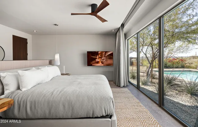 a spacious bedroom with a large bed and a large window